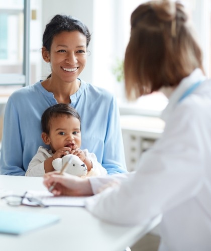 woman and baby talking to doctor